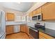 Kitchen featuring granite countertops, stainless steel appliances, and light oak cabinets at 8985 Edgewood Ln, Highlands Ranch, CO 80130