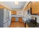 Bright kitchen featuring granite countertops, stainless steel appliances, and light oak cabinets at 8985 Edgewood Ln, Highlands Ranch, CO 80130
