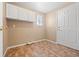 Laundry room features white cabinets and neutral walls at 8985 Edgewood Ln, Highlands Ranch, CO 80130