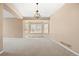 Spacious room with a bay window and decorative chandelier at 8985 Edgewood Ln, Highlands Ranch, CO 80130