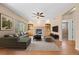 Living room with fireplace, hardwood floors, and an oversized sectional couch at 8985 Edgewood Ln, Highlands Ranch, CO 80130