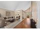 Spacious living room with vaulted ceilings, hardwood floors, and a stylish seating area at 8985 Edgewood Ln, Highlands Ranch, CO 80130