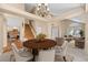 Open-concept living area with elegant dining table, stylish seating, and abundant natural light at 8985 Edgewood Ln, Highlands Ranch, CO 80130