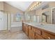 Bright bathroom with shower, soaking tub, double sink vanity, and a large mirror at 8985 Edgewood Ln, Highlands Ranch, CO 80130