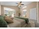 Large main bedroom with vaulted ceiling, fan, and sitting area with natural light at 8985 Edgewood Ln, Highlands Ranch, CO 80130