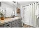 Bathroom with tiled countertop, large mirror, and shower-tub combination, providing a clean and functional space at 3502 Nez Perce Trl, Castle Rock, CO 80109