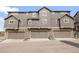 Modern townhome exterior with garages and stone accents; ample parking and curb appeal at 3502 Nez Perce Trl, Castle Rock, CO 80109