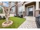 Charming front yard with artificial turf, a birch tree, outdoor seating, and a welcoming entrance at 3502 Nez Perce Trl, Castle Rock, CO 80109