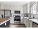 Modern kitchen with stainless steel appliances, granite countertops, and white subway tile backsplash at 3502 Nez Perce Trl, Castle Rock, CO 80109