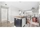 Stylish kitchen island featuring wood countertop, storage cabinets, and seating, enhancing the open-concept living space at 3502 Nez Perce Trl, Castle Rock, CO 80109