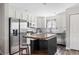 Bright kitchen with stainless steel appliances, white cabinetry, and an inviting breakfast bar at 3502 Nez Perce Trl, Castle Rock, CO 80109