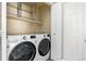 Efficient laundry room equipped with modern washer, dryer, shelving, and ample space for laundry tasks at 3502 Nez Perce Trl, Castle Rock, CO 80109