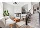 Bright living room with fireplace, staircase, modern decor, and plush seating at 3502 Nez Perce Trl, Castle Rock, CO 80109