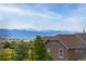 Scenic mountain views from a home with a brown roof, lush trees, and charming surroundings at 3502 Nez Perce Trl, Castle Rock, CO 80109