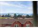 Scenic rooftop view overlooking neighborhood homes with mountains in the distance at 3502 Nez Perce Trl, Castle Rock, CO 80109