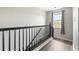 Staircase with sleek black railings and modern gray flooring, connecting levels with style and sophistication at 3502 Nez Perce Trl, Castle Rock, CO 80109