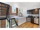 Open layout with stairs leading to kitchen area, bright windows, brick accent wall at 2193 Arapahoe St # 15, Denver, CO 80205