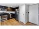 Kitchen with stainless steel appliances, dark cabinets, and light wood-look floors at 2193 Arapahoe St # 15, Denver, CO 80205