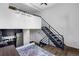 Open-concept living area featuring a modern staircase and cozy rug beneath a lofted space at 2193 Arapahoe St # 15, Denver, CO 80205
