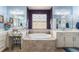 Bathroom featuring a soaking tub, a vanity, and modern fixtures at 18984 W 85Th Blf, Arvada, CO 80007