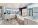 Bright bathroom featuring a soaking tub, double sinks, and vanity area at 18984 W 85Th Blf, Arvada, CO 80007