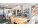 Open-concept dining room featuring a wooden table, modern lighting, and views to the living room at 18984 W 85Th Blf, Arvada, CO 80007