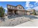 Inviting two-story home featuring a covered porch, stone accents, and an attached three-car garage at 18984 W 85Th Blf, Arvada, CO 80007