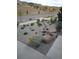 Unique zero-scaped landscaping features a variety of rocks and hearty plants in front of the house at 18984 W 85Th Blf, Arvada, CO 80007