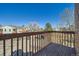 Balcony overlooking the parking lot with wood railing at 11922 Bellaire St # F, Thornton, CO 80233