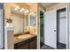 Well-lit bathroom with a functional vanity and an open closet at 11922 Bellaire St # F, Thornton, CO 80233