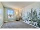 Bright bedroom featuring a woodland mural, plush carpet, and a sun-filled window at 11922 Bellaire St # F, Thornton, CO 80233