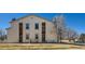Traditional building exterior featuring well-maintained landscaping and parking at 11922 Bellaire St # F, Thornton, CO 80233