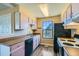 Functional kitchen features a bright window, wood-look countertops and streamlined appliances at 11922 Bellaire St # F, Thornton, CO 80233