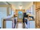 Cozy kitchen with warm lighting, practical layout, and a view of a large window at 11922 Bellaire St # F, Thornton, CO 80233