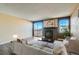 Inviting living room with fireplace, large windows, and sliding glass doors to a private balcony at 11922 Bellaire St # F, Thornton, CO 80233