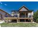 Spacious backyard features a multi-level deck, lush lawn, and mature landscaping at 26566 E Peakview Dr, Aurora, CO 80016