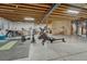 Large basement workout area, including exercise machines and unfinished ceiling at 26566 E Peakview Dr, Aurora, CO 80016