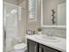 Bright bathroom with a glass shower, a window, and an updated vanity at 26566 E Peakview Dr, Aurora, CO 80016