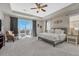 Primary bedroom featuring a sliding glass door to a patio and comfortable seating at 26566 E Peakview Dr, Aurora, CO 80016