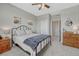 Comfortable bedroom with neutral colors, ceiling fan, and walk-in closet at 26566 E Peakview Dr, Aurora, CO 80016