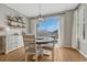 Bright dining area with table, buffet, hardwood floors, and sliding doors to the deck at 26566 E Peakview Dr, Aurora, CO 80016