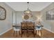 Elegant dining room with hardwood floors, stylish lighting fixture, and ample seating at 26566 E Peakview Dr, Aurora, CO 80016