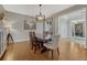 Inviting dining room featuring hardwood floors, a modern chandelier, and comfortable seating at 26566 E Peakview Dr, Aurora, CO 80016