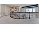 Loft space overlooking living room and stairs with elegant black iron railing at 26566 E Peakview Dr, Aurora, CO 80016