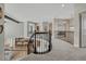 Loft space overlooking kitchen and dining area with elegant black iron railing at 26566 E Peakview Dr, Aurora, CO 80016