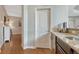 Hallway with granite countertop, undermount sink, and hardwood floors at 26566 E Peakview Dr, Aurora, CO 80016