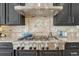 Close-up view of the stainless steel KitchenAid range hood and gas cooktop at 26566 E Peakview Dr, Aurora, CO 80016