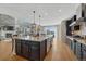 The open kitchen features a large center island and stainless steel appliances at 26566 E Peakview Dr, Aurora, CO 80016