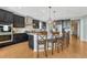 This kitchen features a large center island with dark wood cabinets and stone countertops at 26566 E Peakview Dr, Aurora, CO 80016