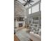 Bright and airy living room with a stone fireplace, vaulted ceiling, and large windows at 26566 E Peakview Dr, Aurora, CO 80016